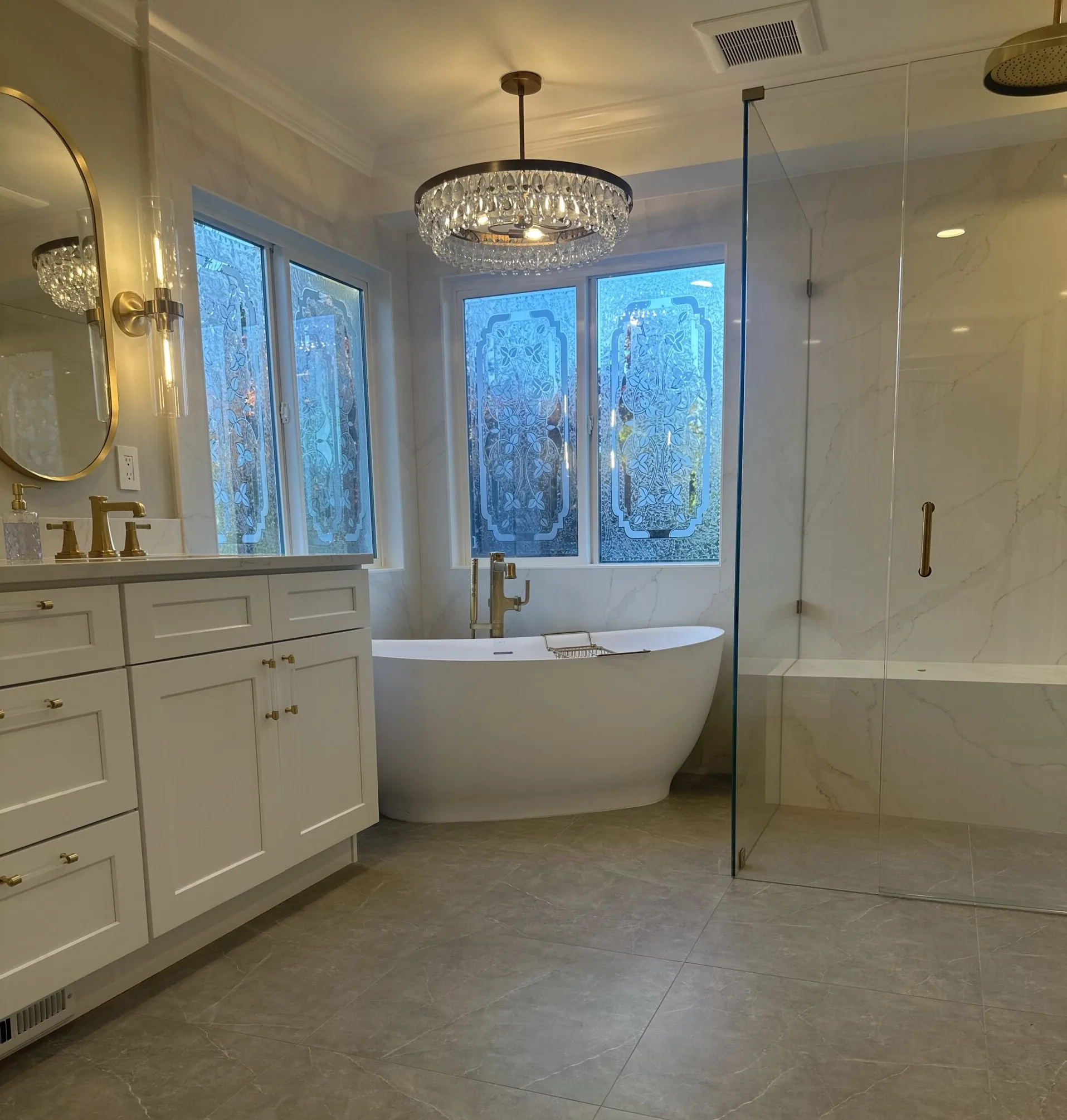 Master bathroom — freestanding tub, chandelier, gold fixtures, Ballard Seattle