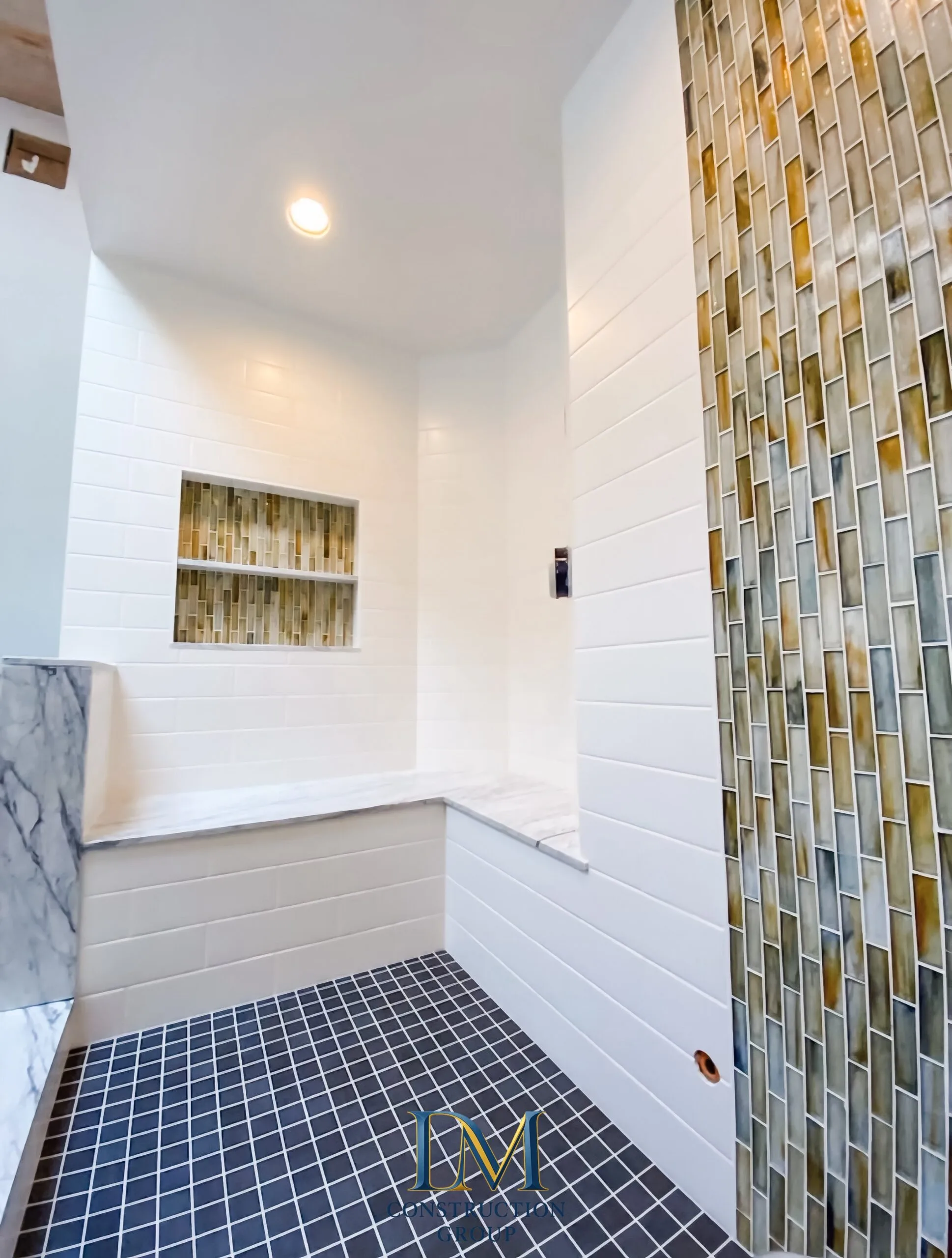 Custom shower — mosaic glass accent tile, subway tile, built-in niche